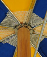 Closeup image of steel rib wood beach umbrella upper hub