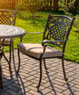 Patio dining chair with tan seat cushion