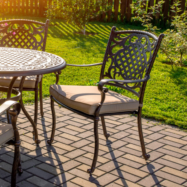 Patio dining chair with tan seat cushion