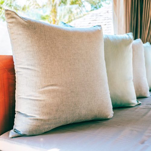 22 inch patio throw pillows sitting on outdoor furniture